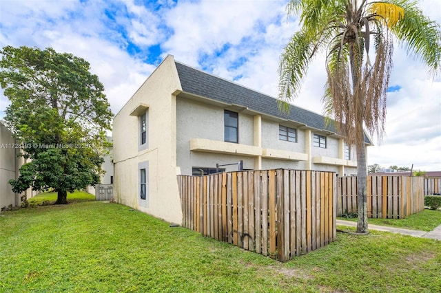 view of side of property with a yard