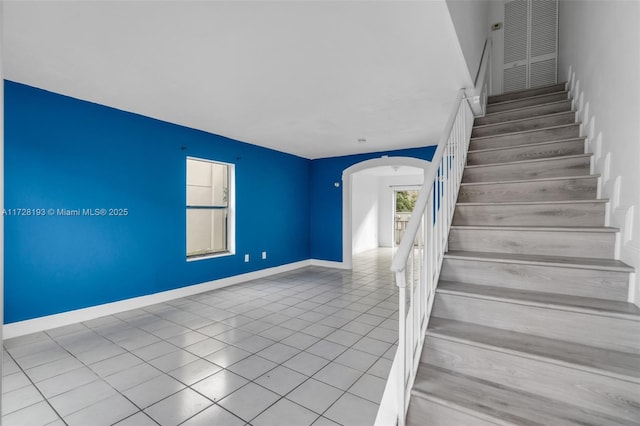 staircase with tile patterned floors