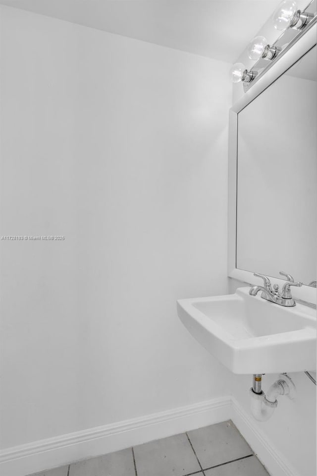 bathroom with sink and tile patterned flooring