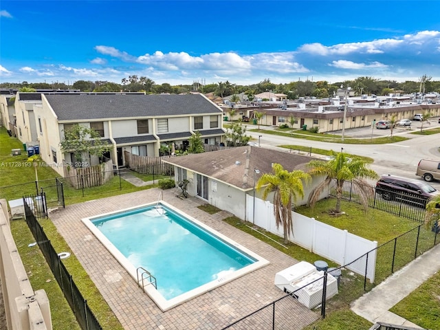 view of pool featuring a lawn