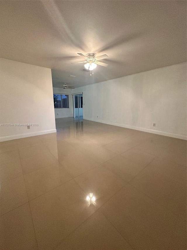 2165 SE Floresta Dr, Port St Lucie, FL 34984 - tiled empty room with baseboards and a ceiling fan