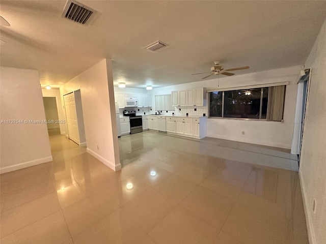 2165 SE Floresta Dr, Port St Lucie, FL 34984 - hallway featuring light tile patterned floors, baseboards, and a sink