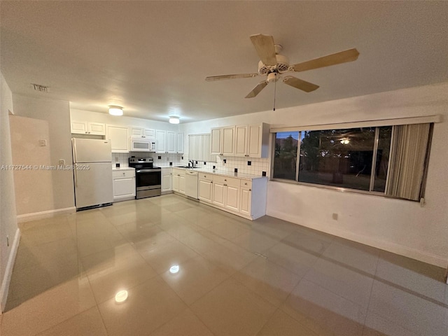 2165 SE Floresta Dr, Port St Lucie, FL 34984 - kitchen featuring appliances with stainless steel finishes, decorative backsplash, baseboards, and ceiling fan