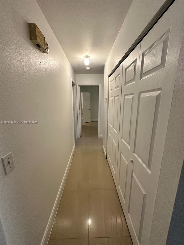 corridor with light tile patterned flooring