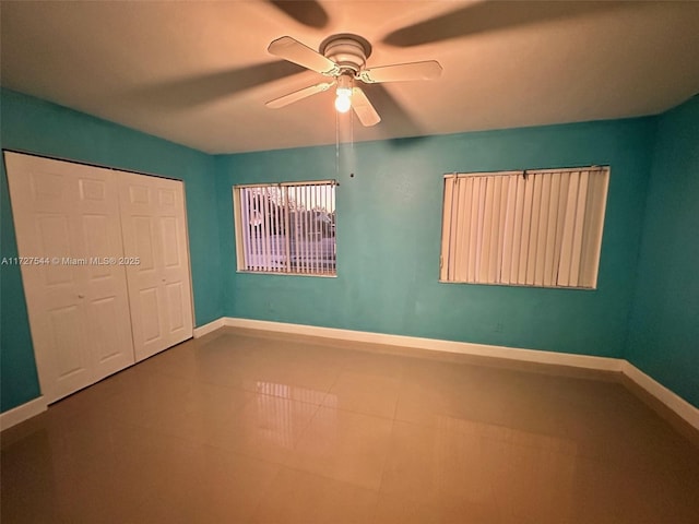 unfurnished bedroom with ceiling fan, a closet, and tile patterned flooring