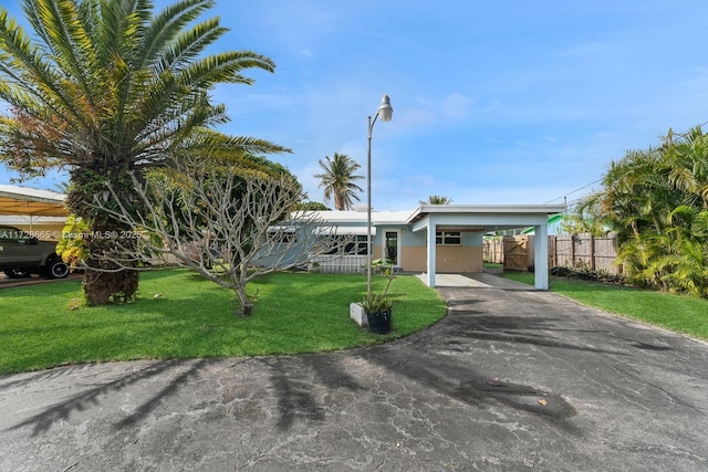 view of front of property with a carport and a front lawn