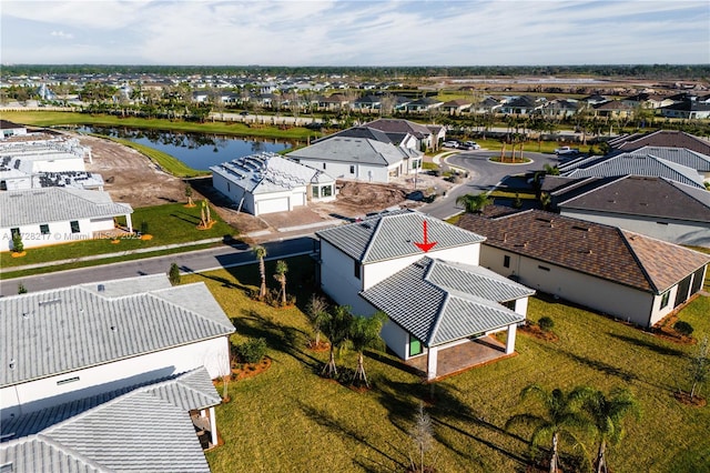 birds eye view of property with a water view and a residential view