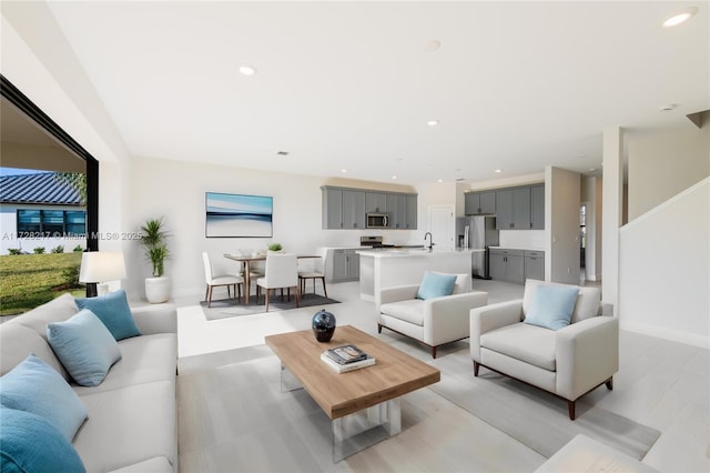 living area with baseboards and recessed lighting