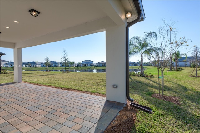 view of patio featuring a residential view and a water view