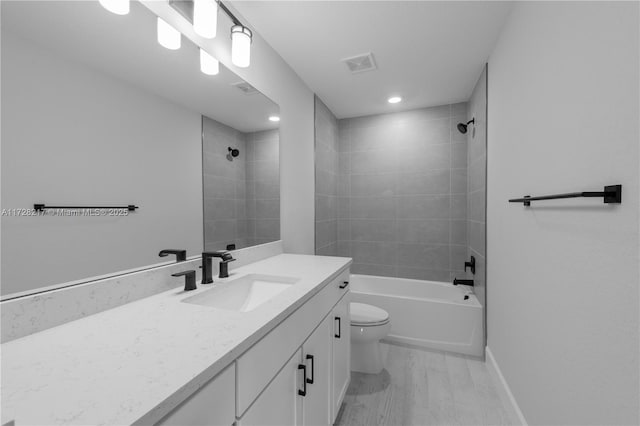 full bathroom featuring visible vents, toilet, vanity,  shower combination, and baseboards