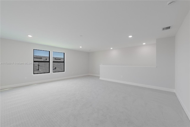 unfurnished room featuring light carpet, recessed lighting, visible vents, and baseboards