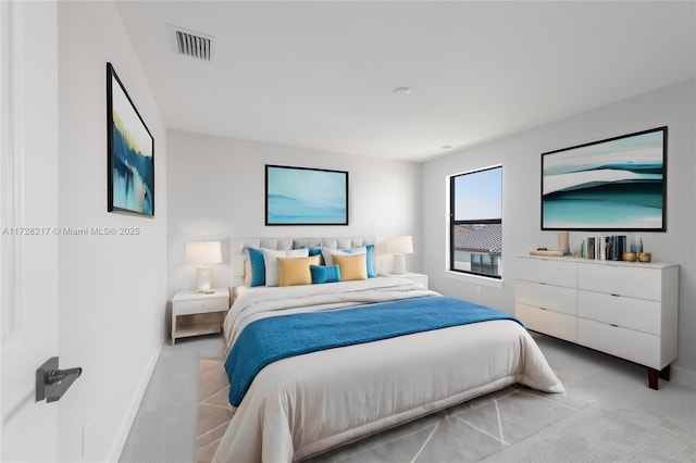 carpeted bedroom with visible vents and baseboards