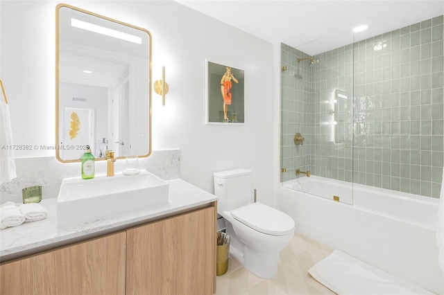 full bathroom with tile patterned floors, toilet, vanity, and tiled shower / bath