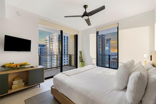 tiled bedroom featuring ceiling fan, access to exterior, and floor to ceiling windows