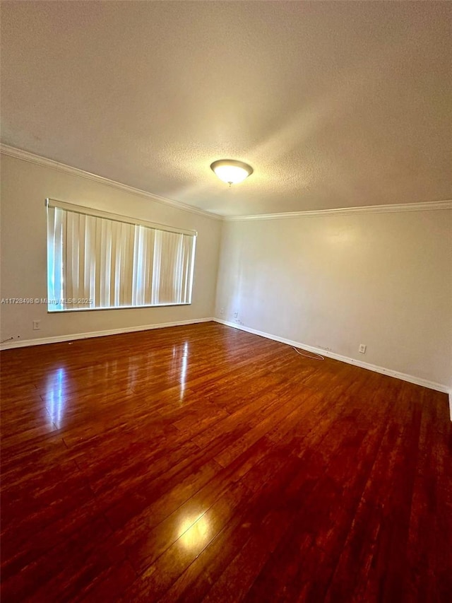 spare room featuring crown molding, a textured ceiling, and hardwood / wood-style floors