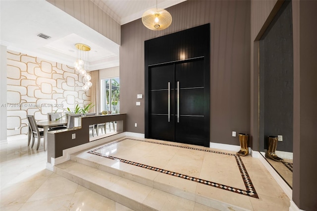 foyer featuring light tile patterned flooring and a chandelier