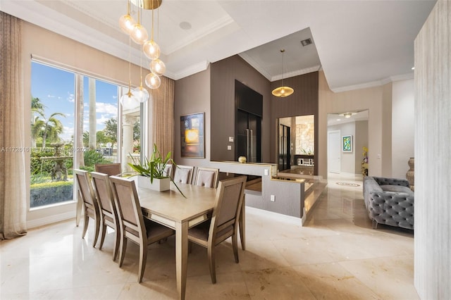 dining space featuring ornamental molding and plenty of natural light