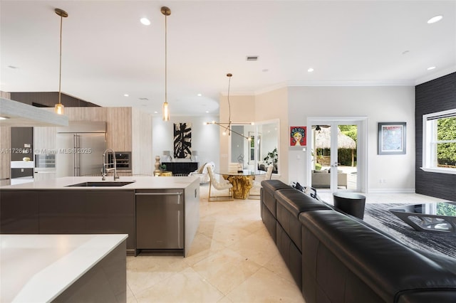 kitchen with sink, pendant lighting, stainless steel appliances, and french doors