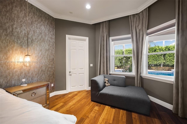 sitting room featuring wood-type flooring and ornamental molding