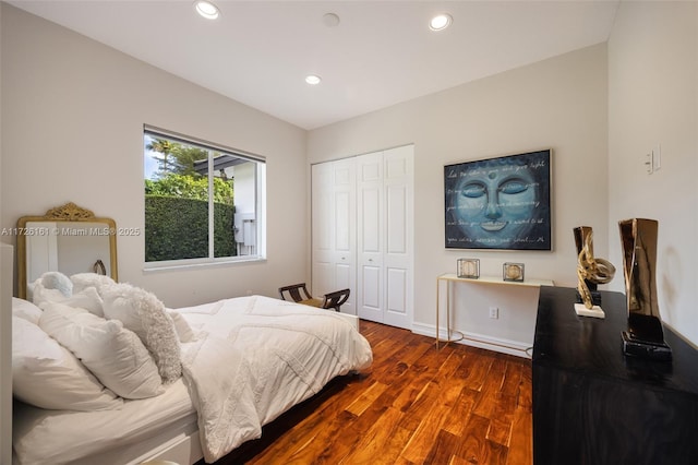 bedroom with dark wood-type flooring and a closet