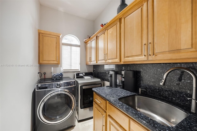 washroom featuring cabinets, washer and dryer, and sink