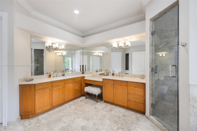 bathroom featuring a shower with shower door, vanity, and crown molding