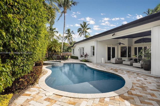 view of pool featuring an in ground hot tub, a patio area, outdoor lounge area, and ceiling fan