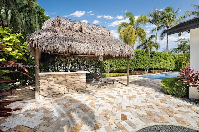 view of patio / terrace featuring a gazebo and a bar