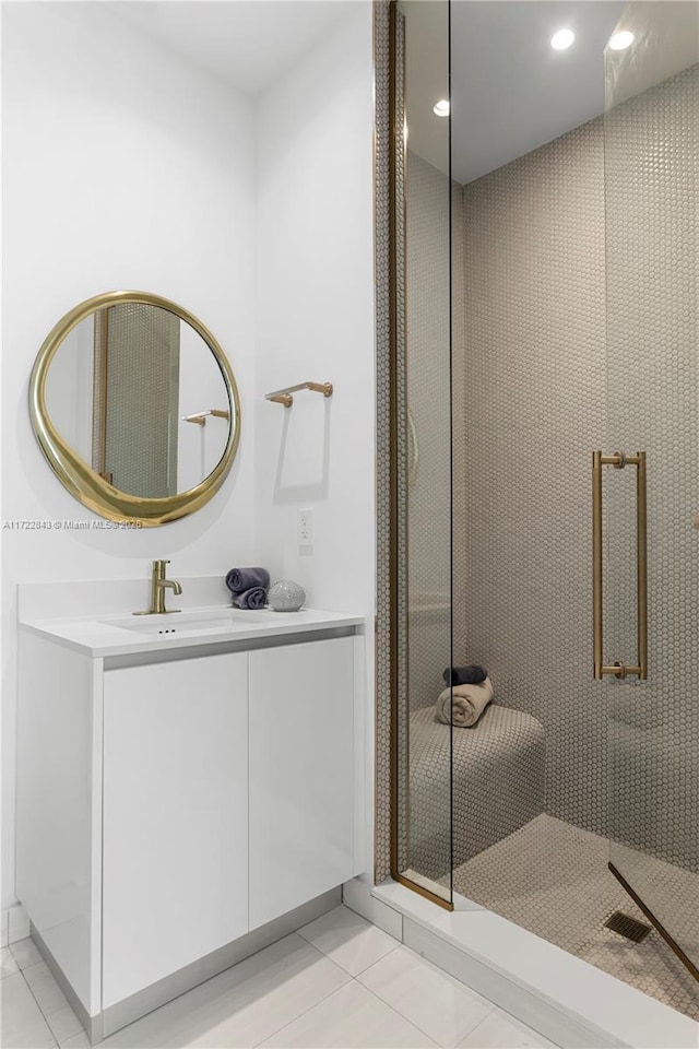 bathroom featuring vanity, tile patterned floors, and a shower with door