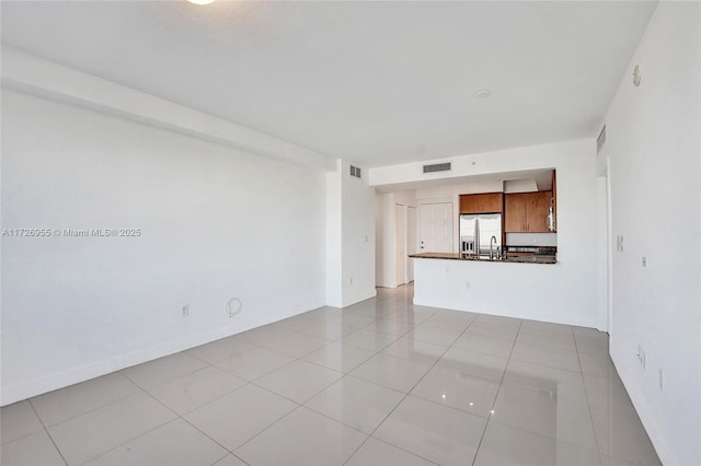 unfurnished living room with light tile patterned floors