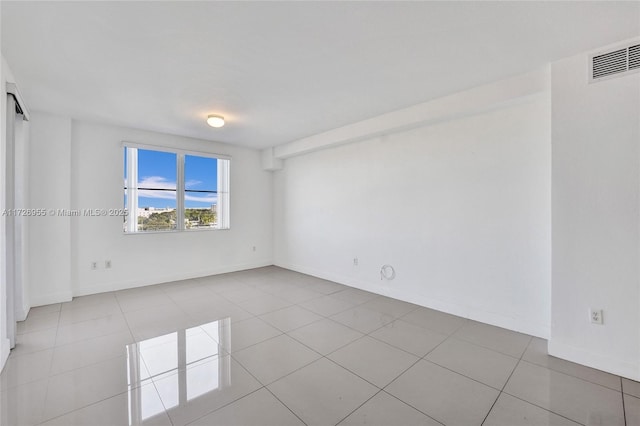 spare room featuring light tile patterned floors