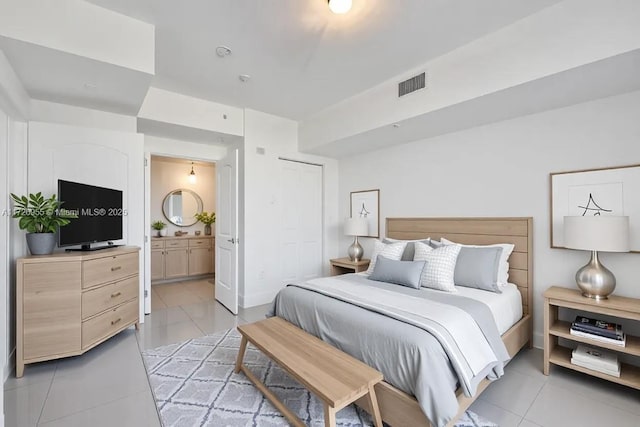 tiled bedroom with connected bathroom