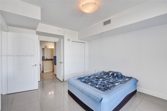 tiled bedroom with a closet