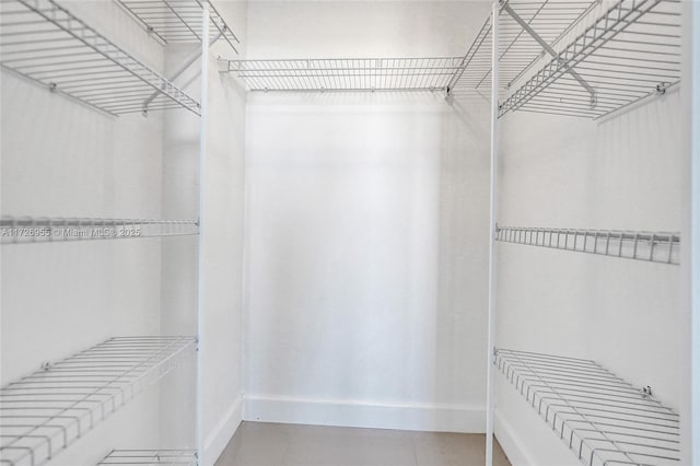 walk in closet with tile patterned flooring