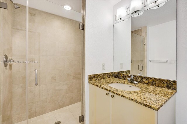 bathroom featuring vanity and an enclosed shower