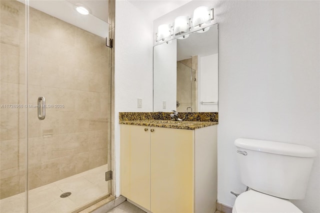 bathroom with toilet, an enclosed shower, and vanity