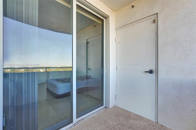 doorway to property featuring a balcony