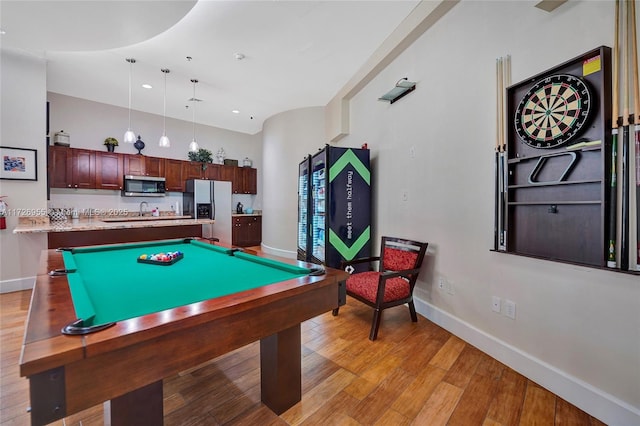 recreation room with light wood-type flooring, sink, and billiards