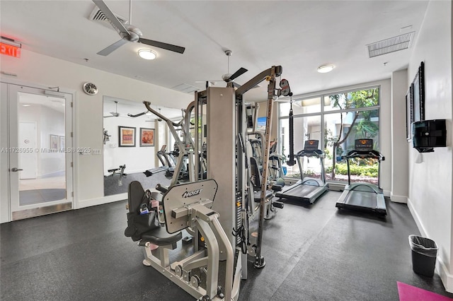 workout area featuring ceiling fan and expansive windows