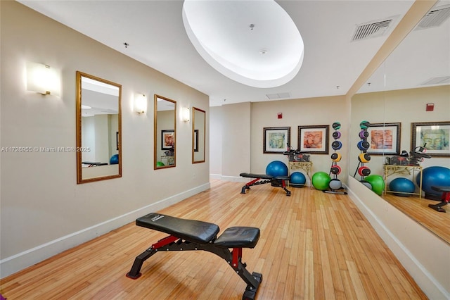 exercise room with wood-type flooring