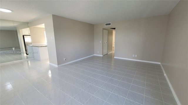 empty room featuring a textured ceiling