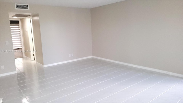 unfurnished room featuring light tile patterned floors