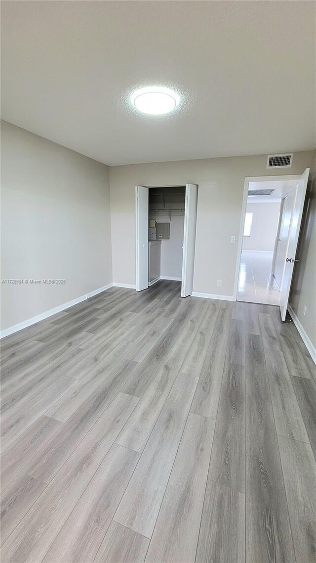 unfurnished bedroom featuring a textured ceiling and light hardwood / wood-style flooring