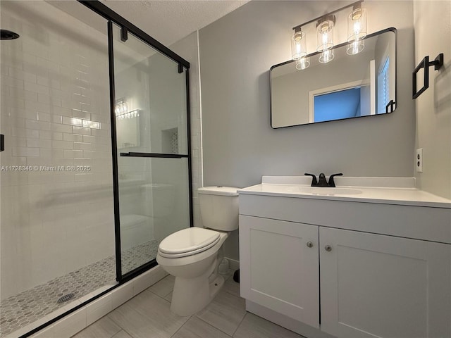 bathroom with walk in shower, tile patterned floors, toilet, a textured ceiling, and vanity