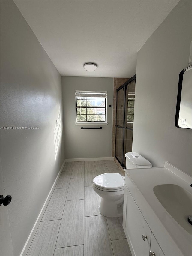 bathroom with vanity, toilet, and walk in shower