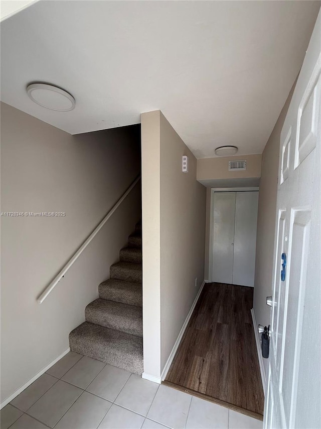 stairs featuring tile patterned floors