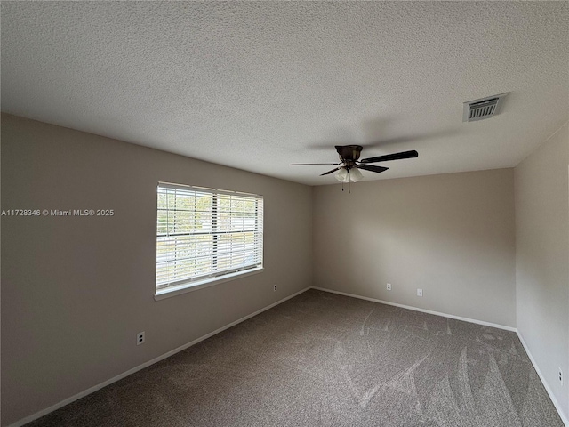 carpeted spare room with ceiling fan and a textured ceiling