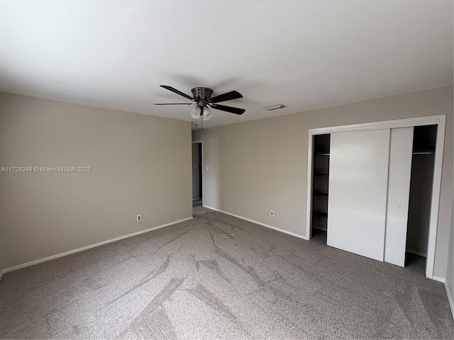 unfurnished bedroom with a closet, ceiling fan, and carpet flooring