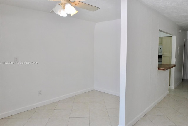 empty room featuring a textured ceiling and ceiling fan