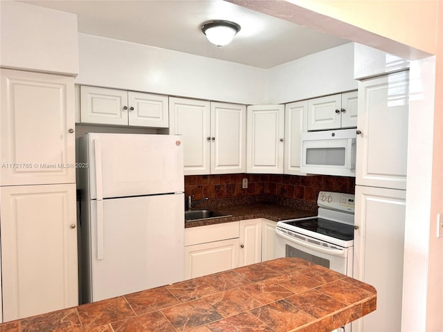 kitchen featuring sink, white appliances, and white cabinets